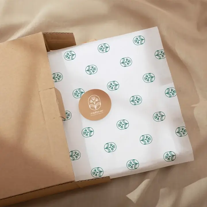 Lightweight white tissue paper sheet featuring a clean green logo pattern for business branding
