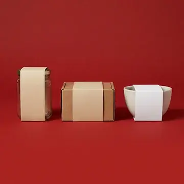 Three examples of custom packaging sleeves: a glass jar, a small cardboard box, and a ceramic bowl.