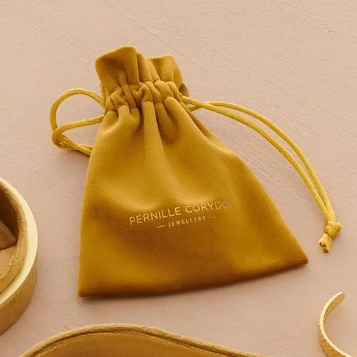 Soft luxury velvet jewelry bags with drawstring and embossed brand name