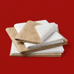 Stack of custom white and kraft tissue papers with floral patterns for gift wrapping and product packaging.